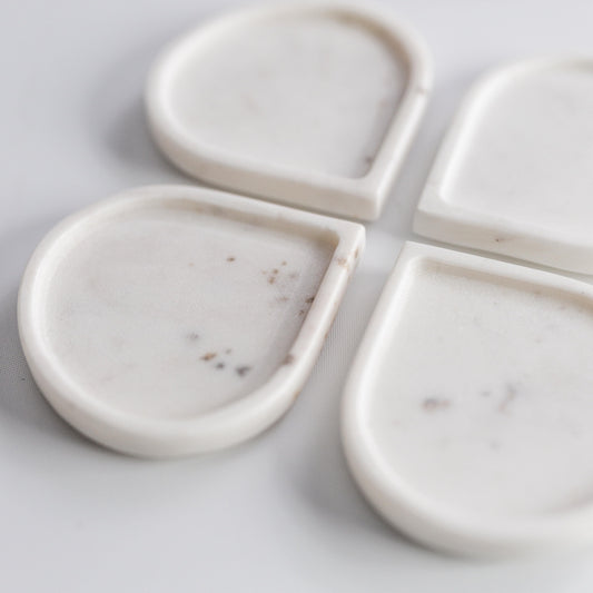 Raindrop marble coaster set, four white teardrop coasters with subtle speckles