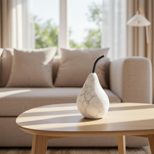Marble pear-shaped candle diffuser with black curved wick on tabletop