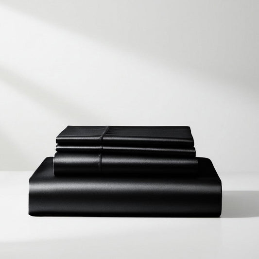 Black satin sheet set, neatly folded flat and fitted sheets