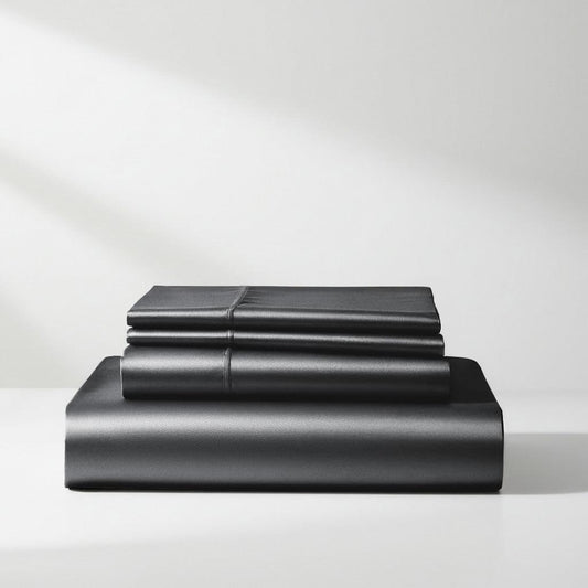 Charcoal grey satin sheet set with fitted and flat sheets, neatly folded stack