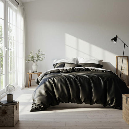 Black satin quilt cover with matching pillowcases and gathered bed design