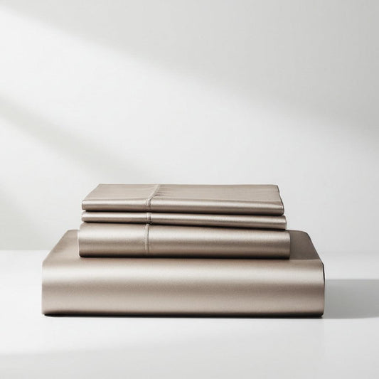 Champagne satin sheet set, folded stack with top sheets and fitted sheet.