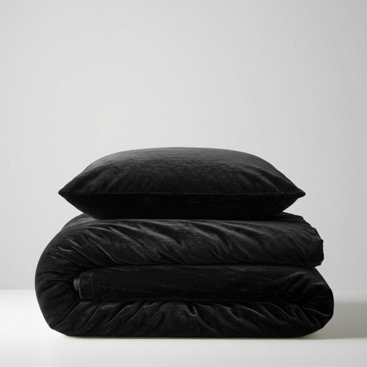Black fur velvet quilt cover with matching pillowcase cushions, folded