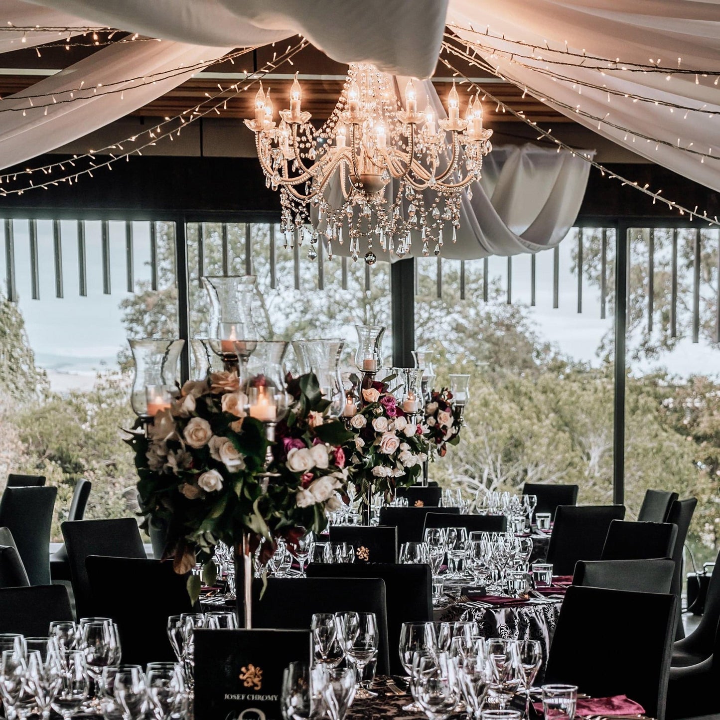 Cassie 12-light chandelier under an outdoor tent, with clear crystal ornaments