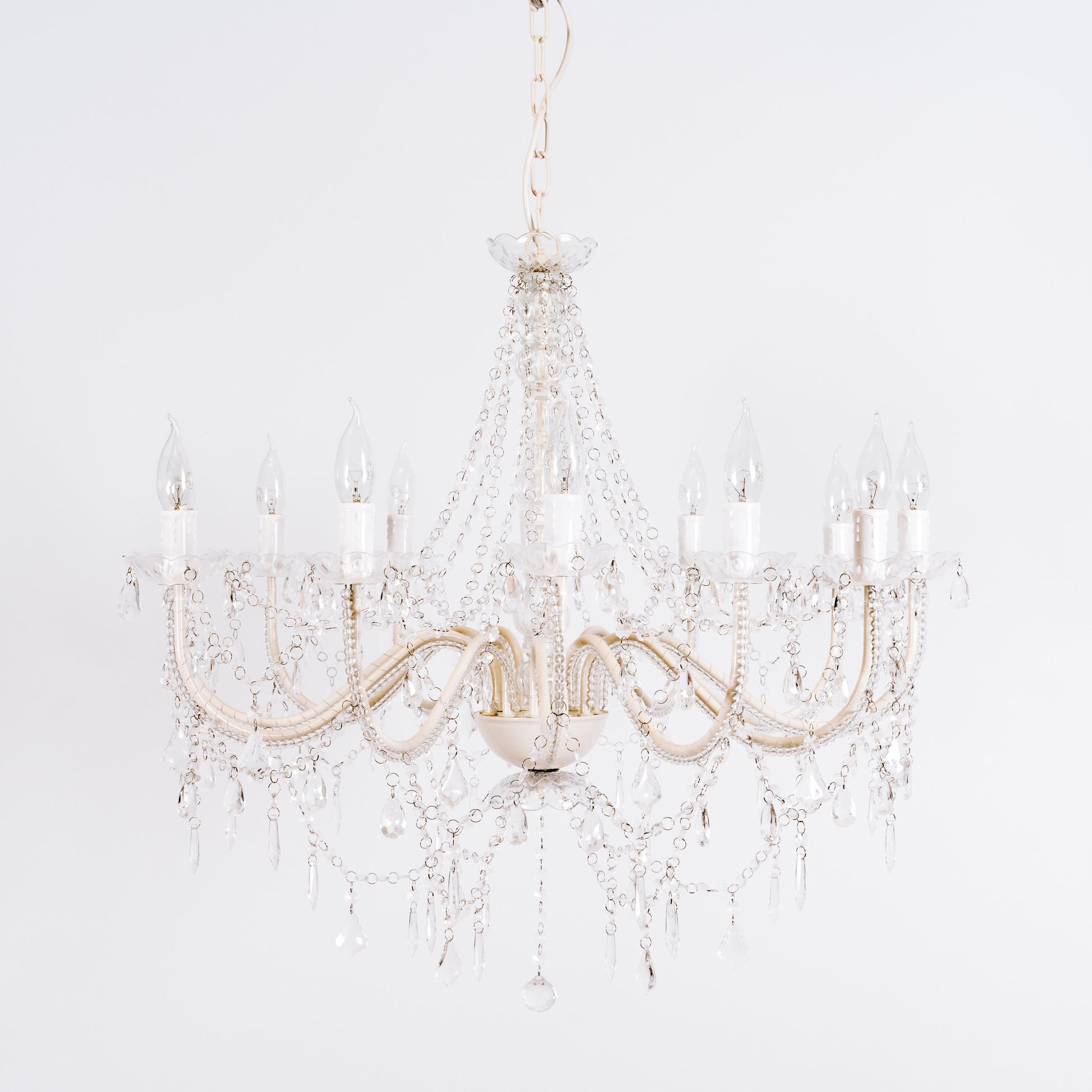 Cassie 12-light chandelier close-up with clear glass crystals and gold-toned arms