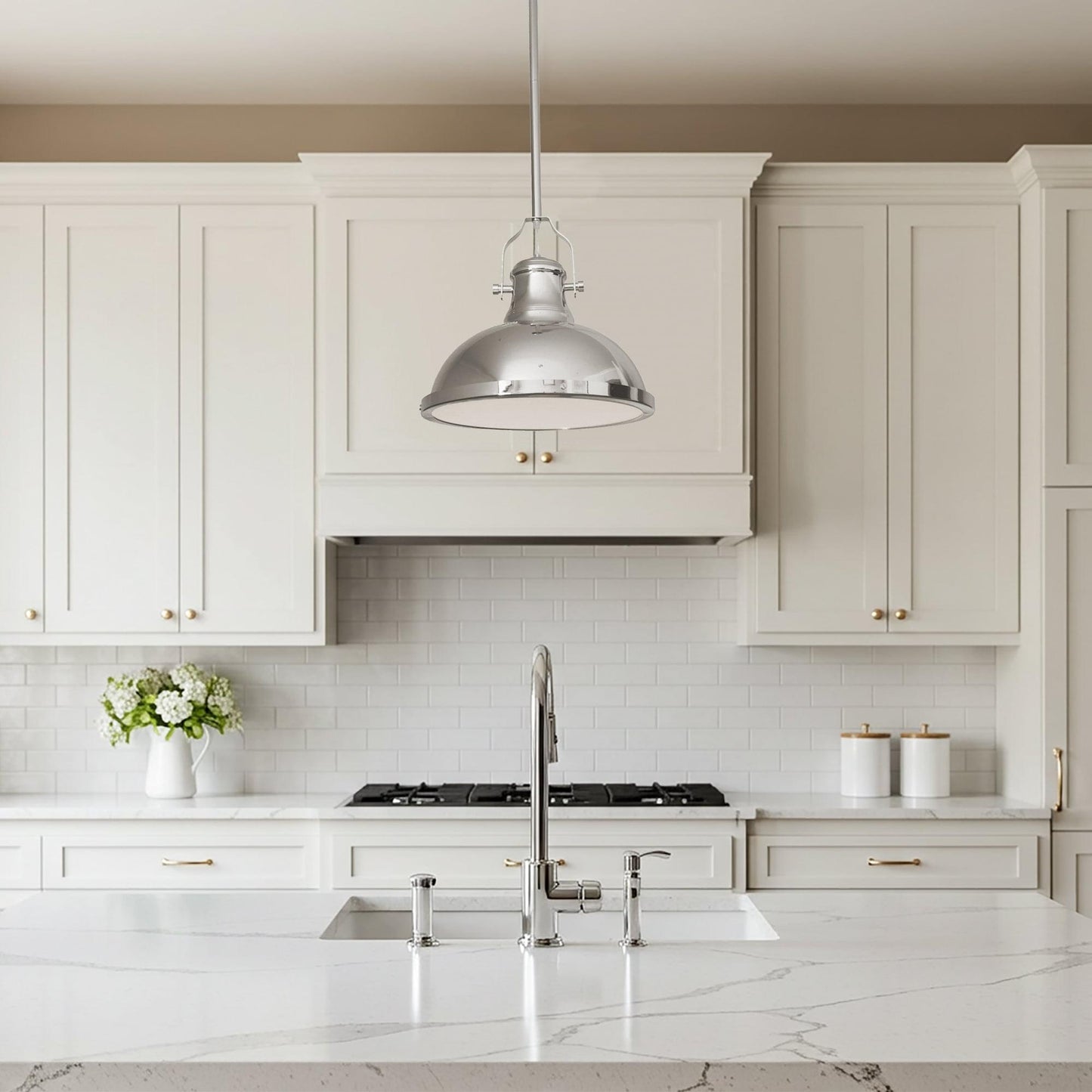 Chrome metal pendant light with domed shade above white kitchen cabinets