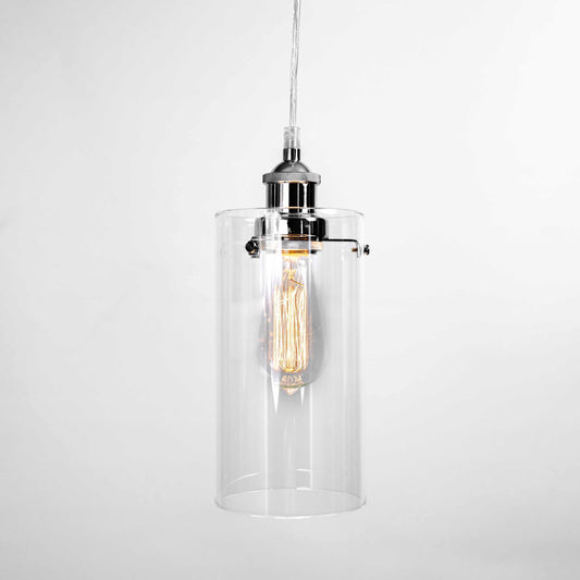 Glass cylinder pendant light with chrome top and warm exposed bulb inside.