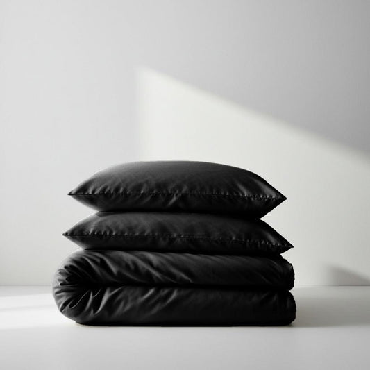 Black quilt cover, folded with matching pillow shams, stitched channel quilting