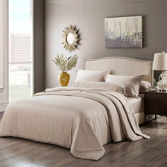 Light beige quilt cover and matching pillowcases on a neatly made bed