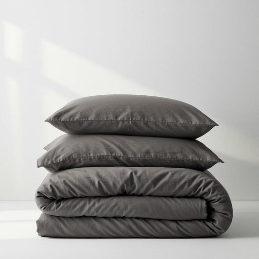 Charcoal quilt cover set with matching pillowcases, folded and stacked neatly