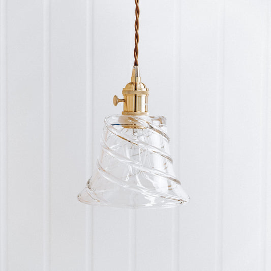 Clear glass pendant with rippled bell shade, brass-toned socket and hanging cord