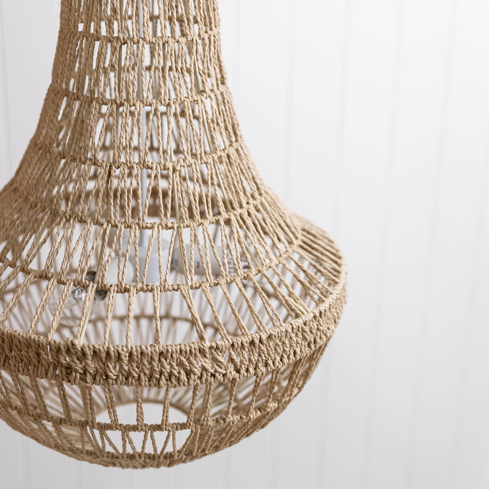 Close-up of natural woven rope pendant chandelier shade with lattice strands