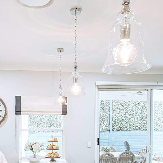 Clear glass bell pendant light with polished chrome fittings and linked metal chain