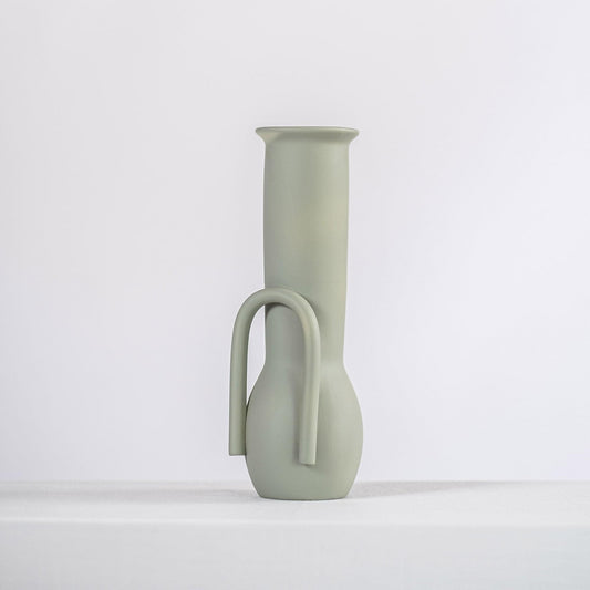 Sage green ceramic vase with loop handle cutout, tall narrow profile