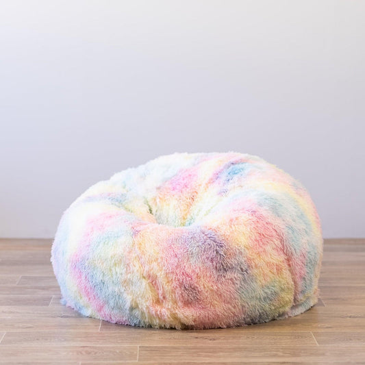 Shaggy rainbow tie-dye bean bag with rounded oval shape and plush faux-fur pile