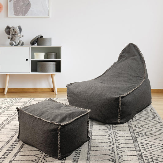 Charcoal fabric bean bag and ottoman set with stitched edging, angled view