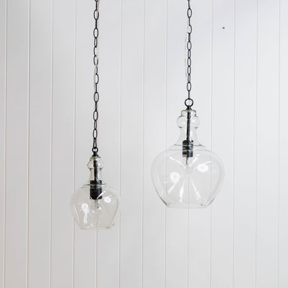 Glass globe pendant light pair on black chain, clear round shades with metal caps
