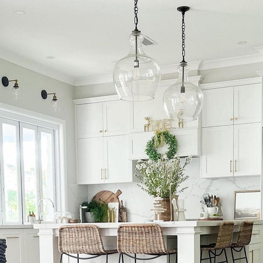 Set of clear glass pendant lights with matte black sockets and hanging chains