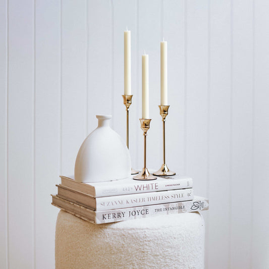 Set of 3 rose-gold taper candlestick holders with fluted cups and weighted bases