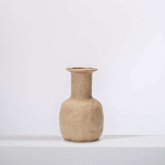 Small textured ceramic vase in clay beige with short flared neck.