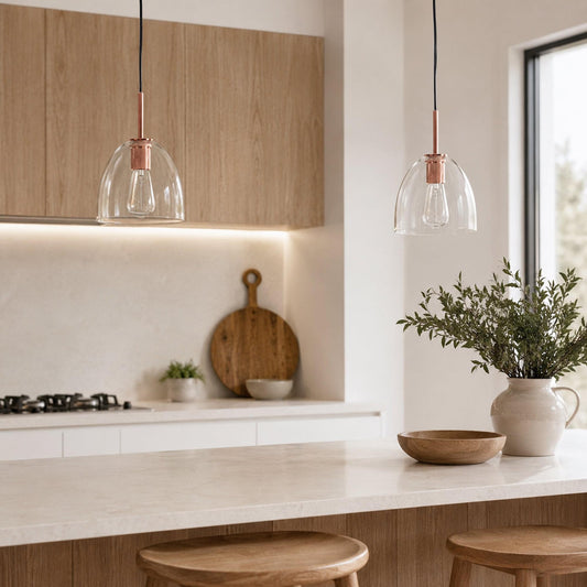 Copper glass pendant light pair with clear bell shades and rose-gold metal stems