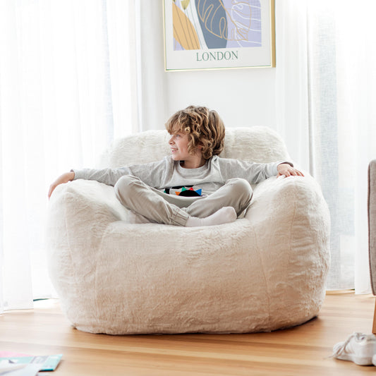 Off-white plush bean bag chair with low rounded back and wide arms