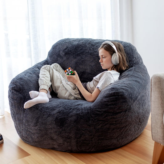 Charcoal gray lounge bean bag chair, thick fuzzy upholstery, wide seat