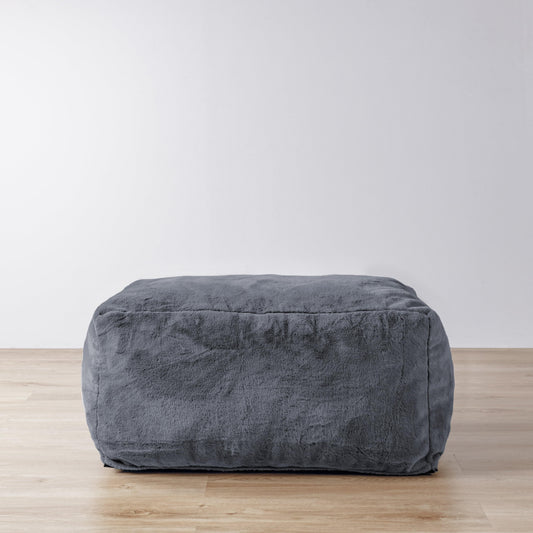 Charcoal gray upholstered ottoman with rounded corners