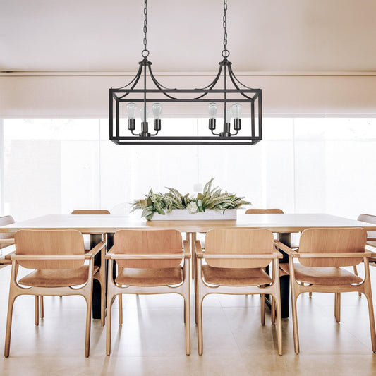 Black rectangular pendant light with glass panels and four exposed bulbs, hanging over table