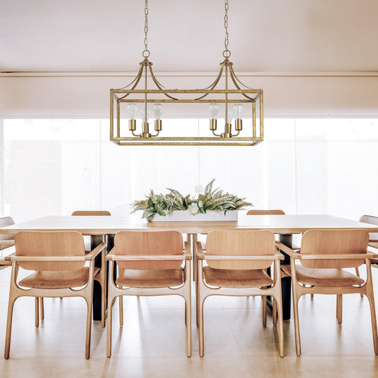 Brushed gold rectangular glass pendant light with four exposed bulbs and hanging chain