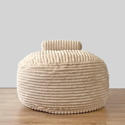 Cream channel-cord round ottoman with curved bolster backrest
