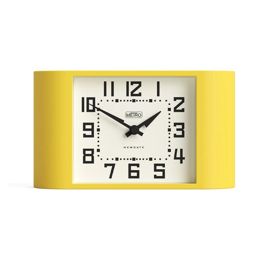 Yellow mantel clock with white dial, black Arabic numerals, and black hands