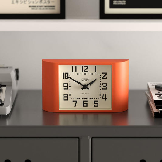 Pumpkin orange mini metro mantel clock showing close-up dial with black minute track