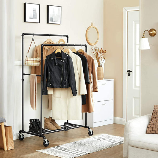 Clothes rack with wheels, dark metal frame with hanging jackets and shirts