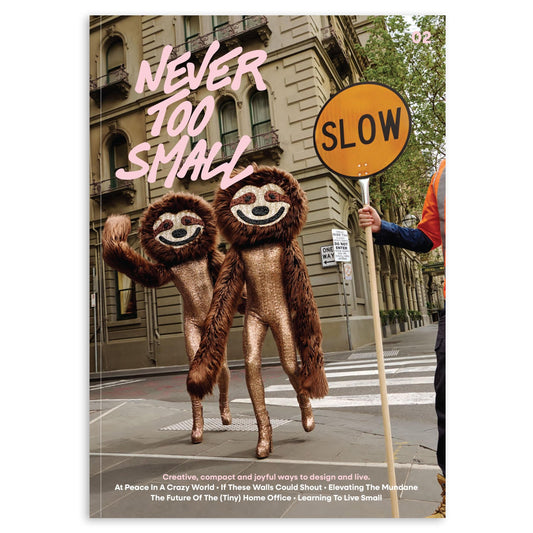 Never Too Small issue magazine cover with bear-shaped characters and street sign