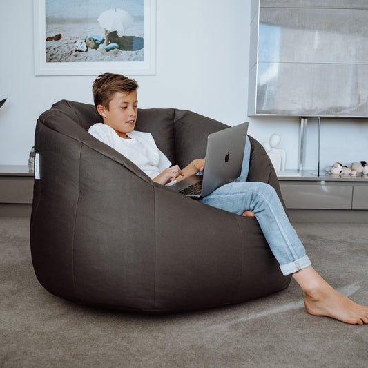 Charcoal bean bag tub chair cover with wide arms, used for casual lounging
