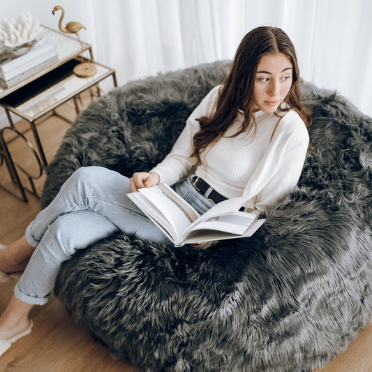 Charcoal faux-fur bean bag with thick, shaggy plush texture