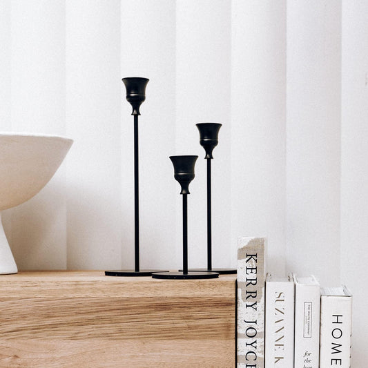 Black 3-piece candlestick set with three taper holders in graduated heights.