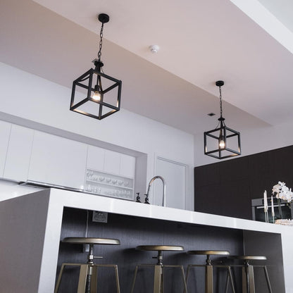 Black lantern pendant light with open metal cage and visible warm bulb