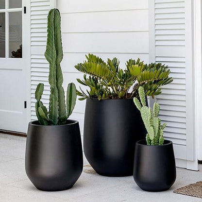 JITT planter set with three dark pots holding cacti and succulents outside
