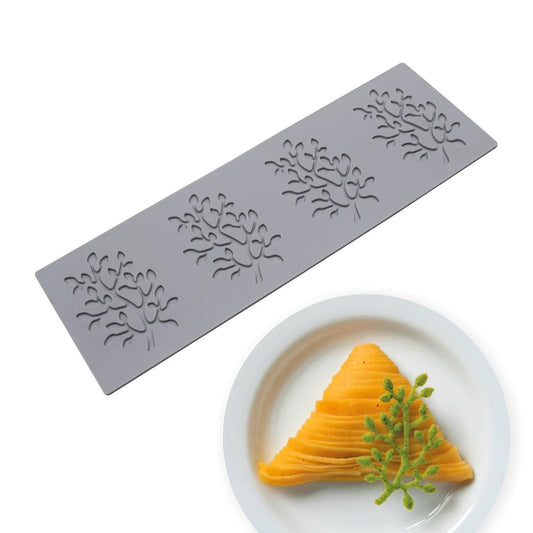 Embossed metal baking mold with tree-branch pattern, molded cake slice shown