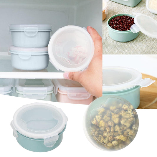 Small plastic bento box set with stacked containers; one open lid and latch shown
