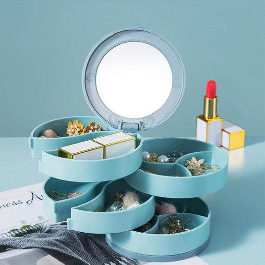 Blue rotating jewelry storage box with open compartments and a circular lid