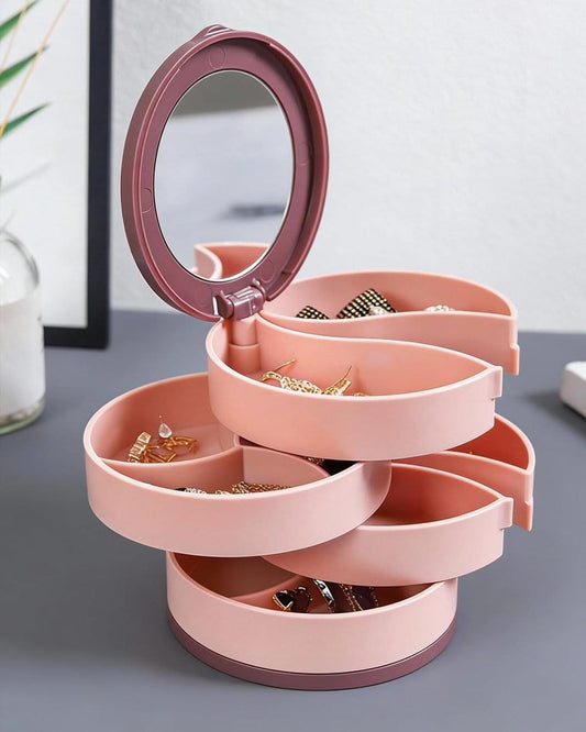 Pink rotating jewelry box with open multi-layer compartments for earrings