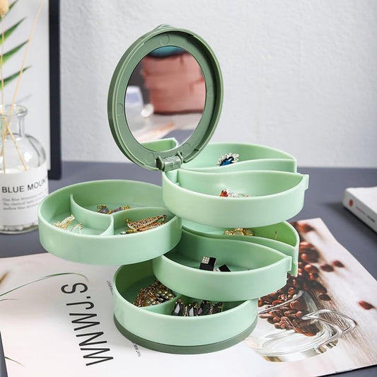 Mint green rotating jewelry box with open circular tiers and round mirror