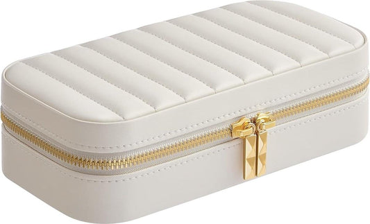 White zippered jewelry box with quilted lid, gold-tone zipper, and clasp.