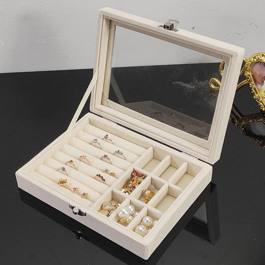 Jewelry box with open glass lid, lock, and divided sections for rings and pearls