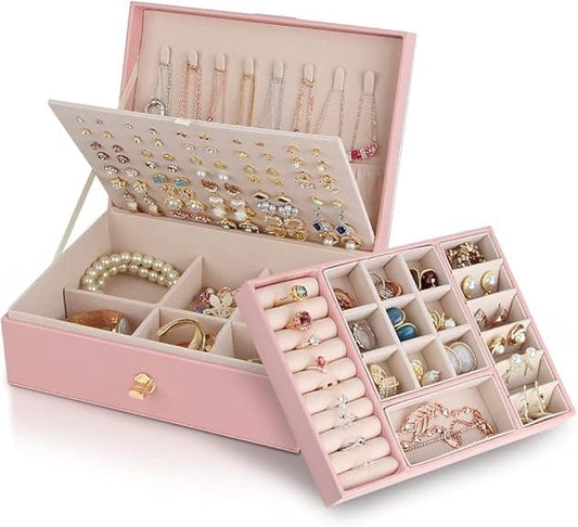 Pink jewelry box with three-tier compartments, holding necklaces, earrings, and rings