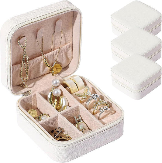 Portable leather jewelry organizer box set in white, open with divided ring and necklace slots