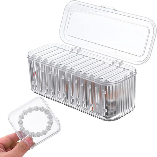 Clear jewelry organizer with open lid and ribbed insert compartments plus ring tray